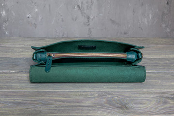 Fragment, close up of green leather elegant women handbag. Horizontal orientation.