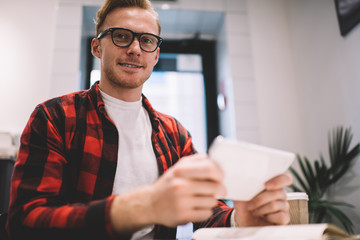 Content freelancer surfing smartphone during work