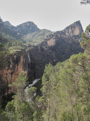 A waterfall falls on the Guadalquivir River in the Natural Park of the Sierra de Cazorla, Segura and Las Villas. In Jaén, Andalusia. Spain