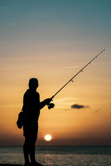 silhouette of fisherman fishing during sunset, Havana, Cuba
