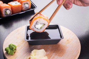 California sushi rolls on dark wooden table
