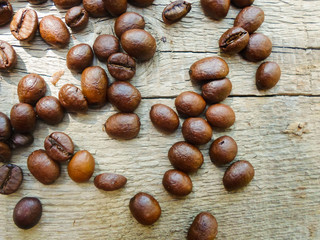 large grains of coffee on a wooden table. place for text