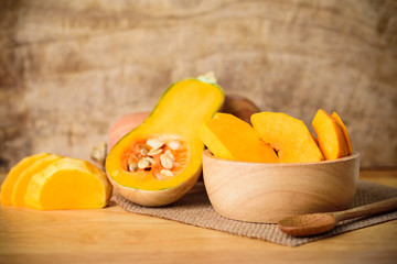 Sliced butternut squash on wooden background