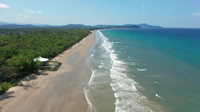 4K Aerial footage view of ocean waves crashing on Beautiful beach by at Sabandar Beach, Tuaran, Sabah, Malaysia