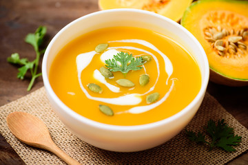 Butternut squash soup with pumpkin seed and cream in bowl