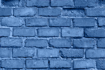 Old red brick wall in Italy. Faded red color, a bit dirty. Copy space for text. Toned in modern blue color 2020
