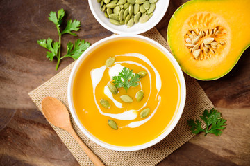 Butternut squash soup with pumpkin seed and cream in bowl