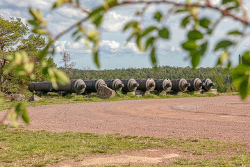 Obraz premium Ancient cast iron cannons, Bomarsund fortress, Sund, Aland Islands, Finland The old ruins of a fortress &nbsp; Red brick