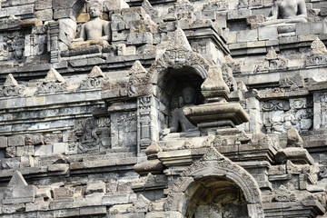 Fototapeta premium (Selective focus) Stunning view of the Borobudur Temple decorated with beautiful relief panels and Buddha statues. Borobudur is a Mahayana Buddhist temple in Central Java, Indonesia.