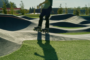 Skateboarder on a pump track park. Skateboarder practice on a pump track park on a sunny summer day