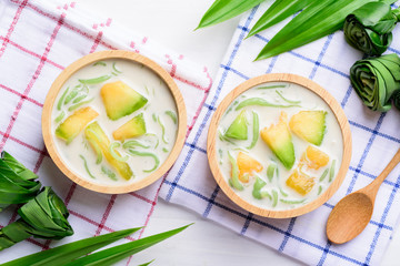 Thai dessert (Lod Chong), rice flour pandan flavor and sliced melon fruit in coconut milk