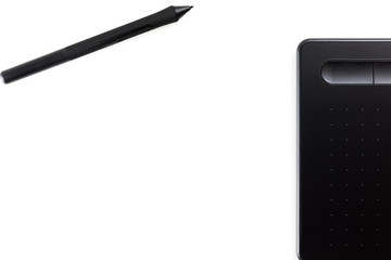 Graphic tablet with pen on white background, isolated, top view