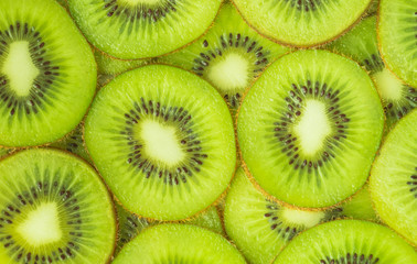 Horizontal image of kiwi slices in the foreground. Food concept, background. Flat lay.