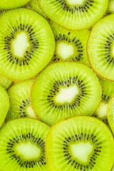 Vertical image, flat lay of kiwi slices.