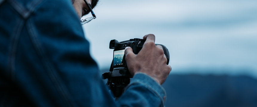 Man Looking Through Camera Viewfinder