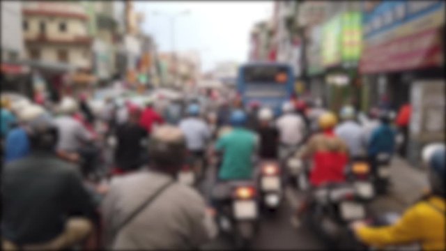 Defocused, blurry, blurred of slow moving traffic with a lots of motorcycles, motorbike, bus, car... transport on the road. Stock footage of urban infrastructure problem, traffic congestion asia