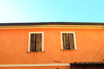 facade of an old house, two windows 