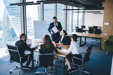 Executive talking with colleagues during business meeting