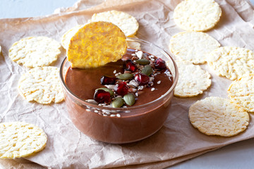 Chocolate hummus with corn chips. The concept of proper nutrition. It is made from ground chickpeas with the addition of cocoa powder and honey.