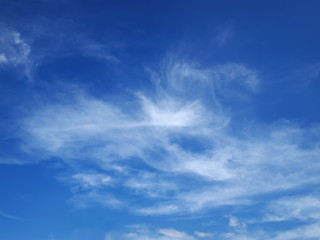 Naklejka na ściany i meble Beautiful white clouds on the blue sky background.