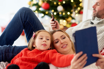 Fototapeta na wymiar Family using technology at Christmas