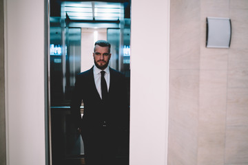 Thoughtful businessman standing and looking away while elevator doors closing © BullRun