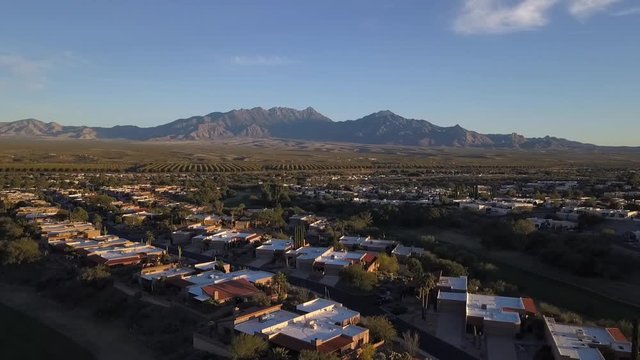 Aerial of a desert town neighborhood with mountain views