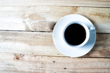 Top view of Coffee cup and saucer on a wooden table