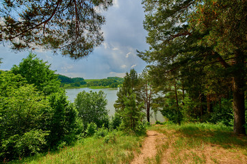 Peaceful rural summer european landscape with green trees and water