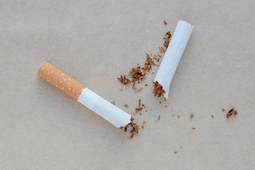 Broken cigarette on a neutral background. Healthy lifestyle concept.