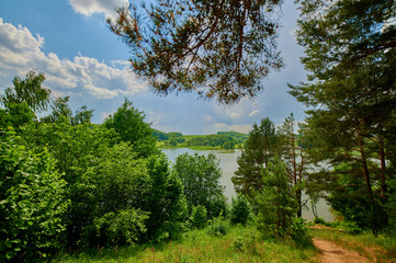 Peaceful rural summer european landscape with green trees and water