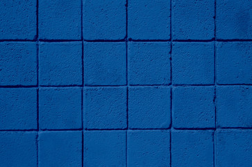 Trend color 2020 classic blue, top view, layout for design. Tile background in trendy dark blue. Wall of blocks, the idea of painting walls for interior design. Trendy color concept of the year.