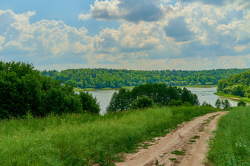 Obraz premium Peaceful rural summer european landscape with green trees and water