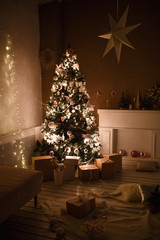 Decorated for the new year interior of the house-the General plan. Christmas tree and decorated Studio, lights garlands, decorations, gift boxes in a cozy home.