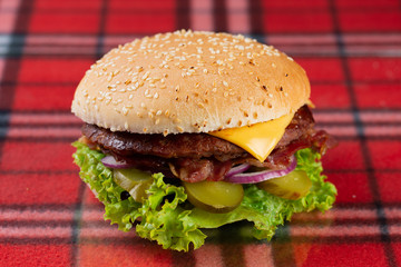  beef burger with cheese, fresh tomatoes and cucumber, onions. sesame seed bacon roll