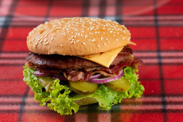  beef burger with cheese, fresh tomatoes and cucumber, onions. sesame seed bacon roll