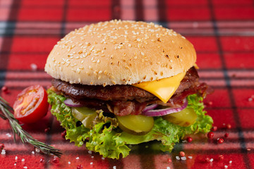  beef burger with cheese, fresh tomatoes and cucumber, onions. sesame seed bun