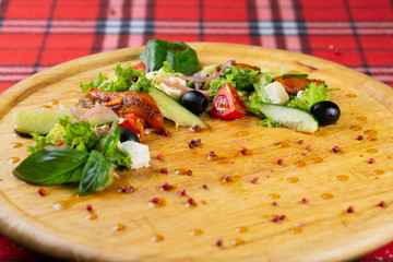 Vegetarian salad of pickled vegetables and cheese. Greek satate with pepper, cucumber, cheese, olives and lettuce seasoned with olive oil