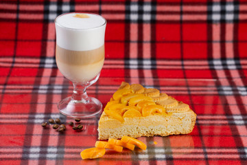 hot coffee with latte milk with a delicious dessert of apricots and peaches