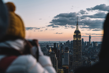 Fototapeta na wymiar Person taking photo of evening Manhattan