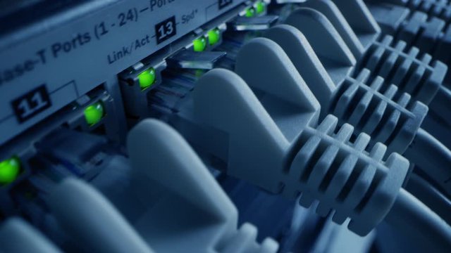 Macro Shot: Ethernet Data Cables Connected to Router Ports with Flashing Lights. Telecommunications: RJ45 Internet Connectors Plugged into Modem LAN Switches. Side View Elevated Moving Camera 