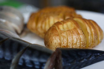 Baked golden potatoes with herring mackerel