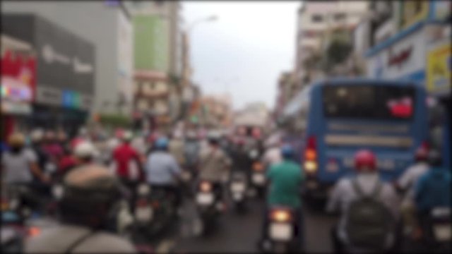 Defocused, blurry, blurred of slow moving traffic with a lots of motorcycles, motorbike, bus, car... transport on the road. Stock footage of urban infrastructure problem, traffic congestion asia