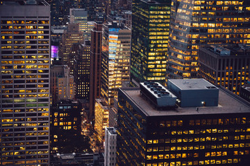 Aerial view of various high Manhattan skyscrapers buildings with lighted windows located in New...