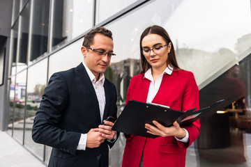 Happy business colleagues in modern office using tablet.