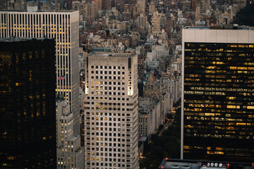 Aerial view of various high Manhattan skyscrapers buildings with lighted windows located in New...