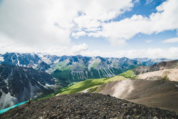 Spectacular view to scenic valley with big beautiful mountain lake surrounded by giant snowy ranges and glaciers. Amazing atmospheric highland landscape. Wonderful majestic wilderness nature scenery.