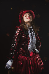 Fototapeta premium Circus artist shapito in a bright red suit and top hat, a girl in a festive outfit