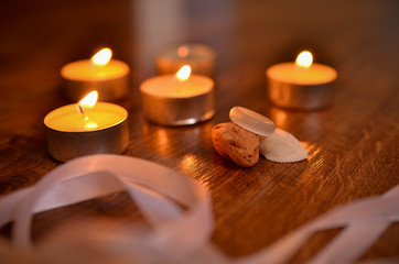 Lighted candles and paraphernalia for the magic rite. Ring made of natural stone. 