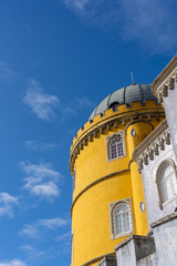 The famous Palce de Pena in Sintra, Portugal. The building stands out for its colorful colors and is located in the hills and forests outside of Lisbon